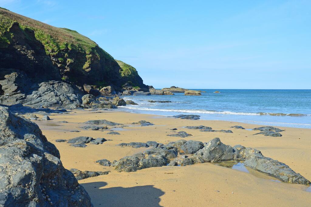 Poldhu rocks and sea caves are exposed at low tide.