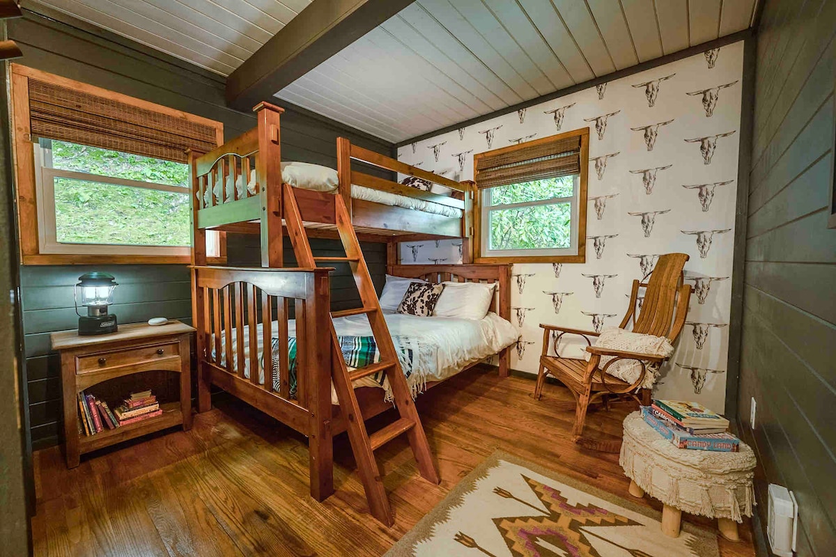 Curated for kids, the bunk room offers a cozy spot for books and board games. The bunk ladder is removable. The rocking chair is perfect for babies. This room stays impeccably dark which makes it great for naps. 