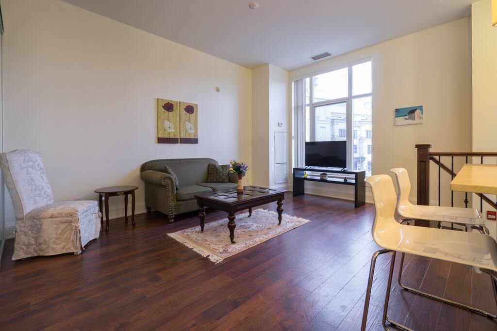 The condo is designed like a townhouse on the first floor which opens to the street however since it is a 10 feet ceiling condo, there are 3 stairs that connects the foyer to the rest of the condo space.