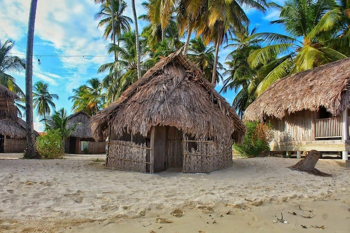 The cabins are simple with a sand floor and made of local elements.
