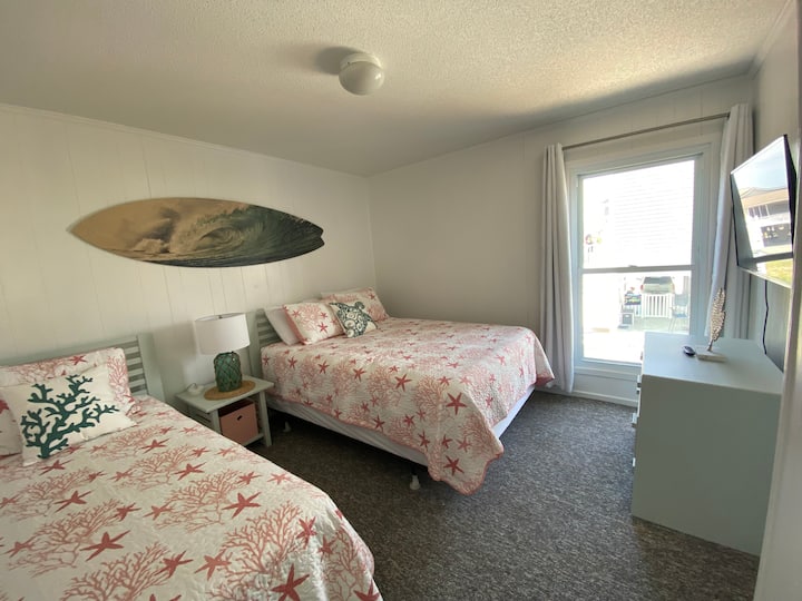 Surfs Up in bedroom 2 on the main level featuring 1 queen + 1 twin bed along with a new 43 inch screen smart TV. 