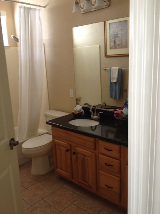 2nd of 2 bathrooms with bathtub, shower, and two sinks