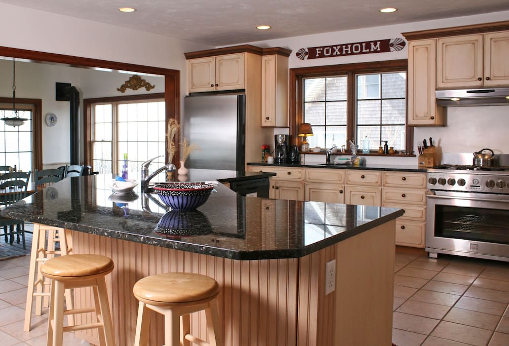 Raised gourmet kitchen with all new stainless steel appliances, large island, 2 sinks, fully stocked pantry, ice maker, lobster pots, grilling utensils, panoramic water views. Overlooks the dining room and Great room. HEAVENLY.