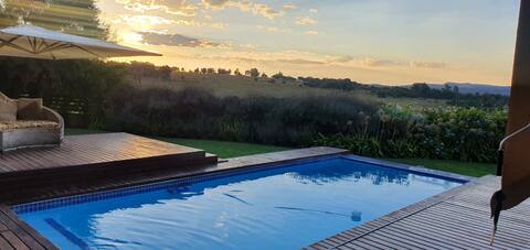 Sip golden sunsets from this endless decked patio