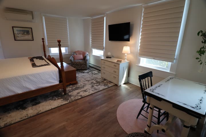 Upstairs bedroom #4. Largest bedroom with King bed,  tv,  and work area. 