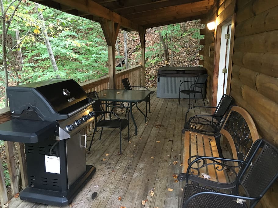 View of left covered deck showing hot tub and propane grill