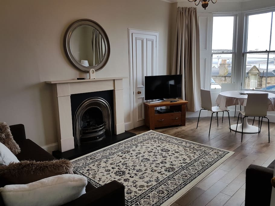 Large living room with dining table. 2 double sofa beds