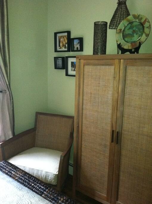 Bedroom has seating area for relaxing by the window
