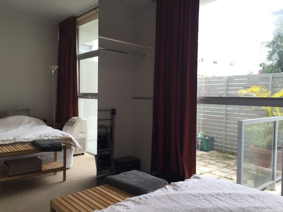 Your room with huge built-in wardrobes and view onto private courtyard.