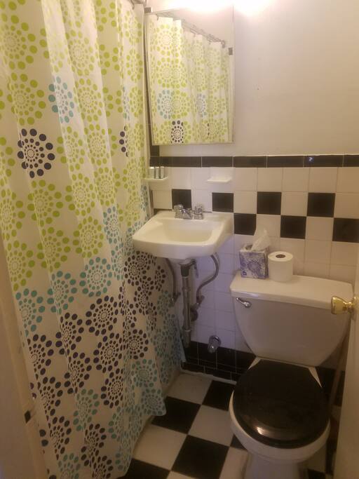 Bathroom has full tub and is stocked with soaps, tissue,etc.