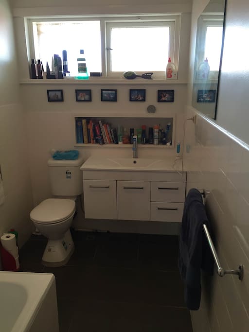Modern, clean bathroom with bath and shower.