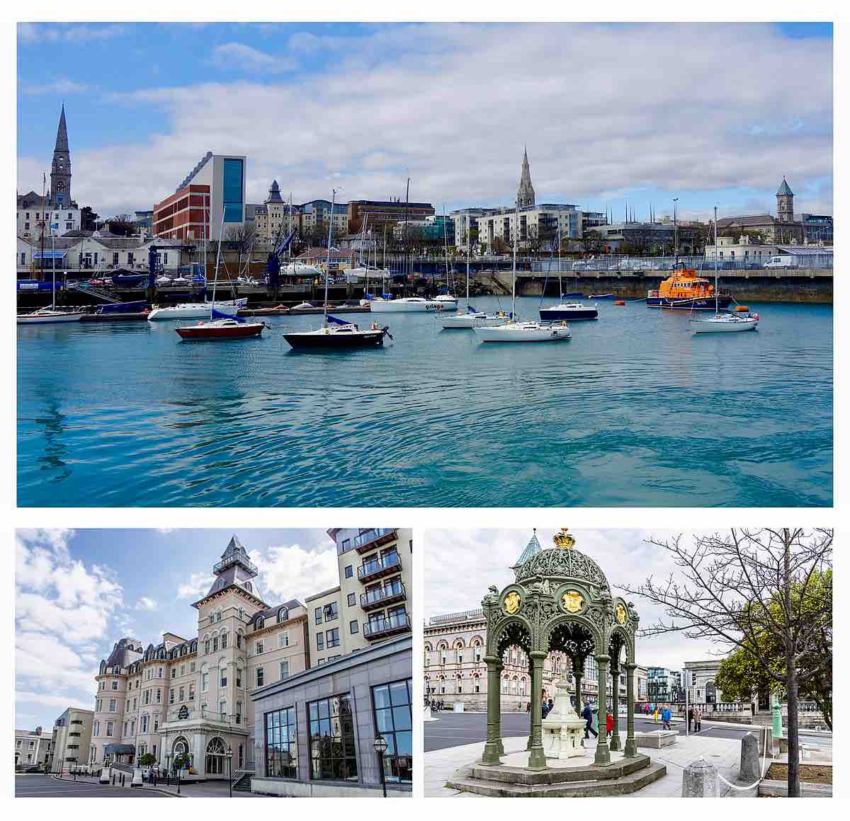 A scenic waterfront view displays multiple sailboats anchored in calm waters, with a backdrop of city buildings and steeples under a partly cloudy sky. The lower section features an historic waterfront structure and a decorative clock tower, alongside tree-lined pedestrian pathways.