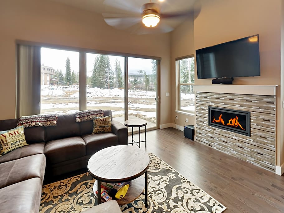 Relax by the fireplace on the sectional sofa and enjoy the 55” TV with cable and a surround sound system.