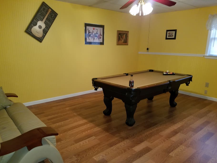 living room area where you can watch television and or shoot pool