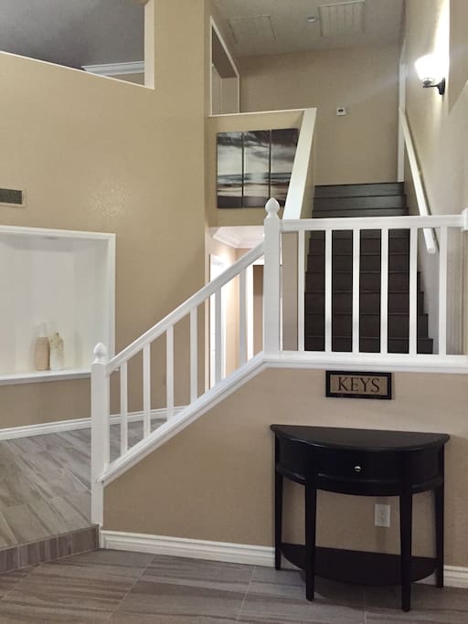 Initial sight upon entrance. Stairwell leading to the upper level of the house.