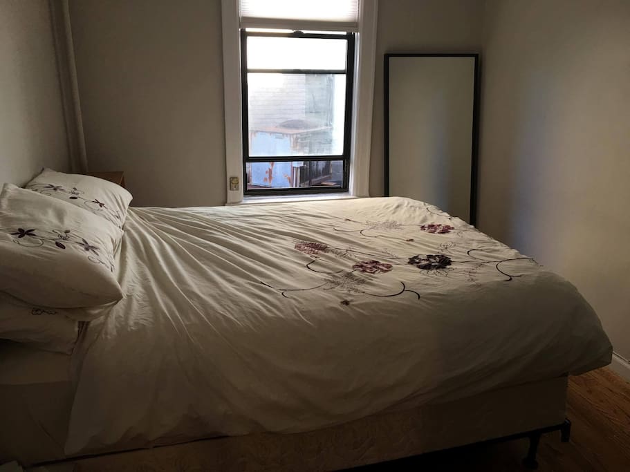 Bedroom with double bed, large mirror and window,