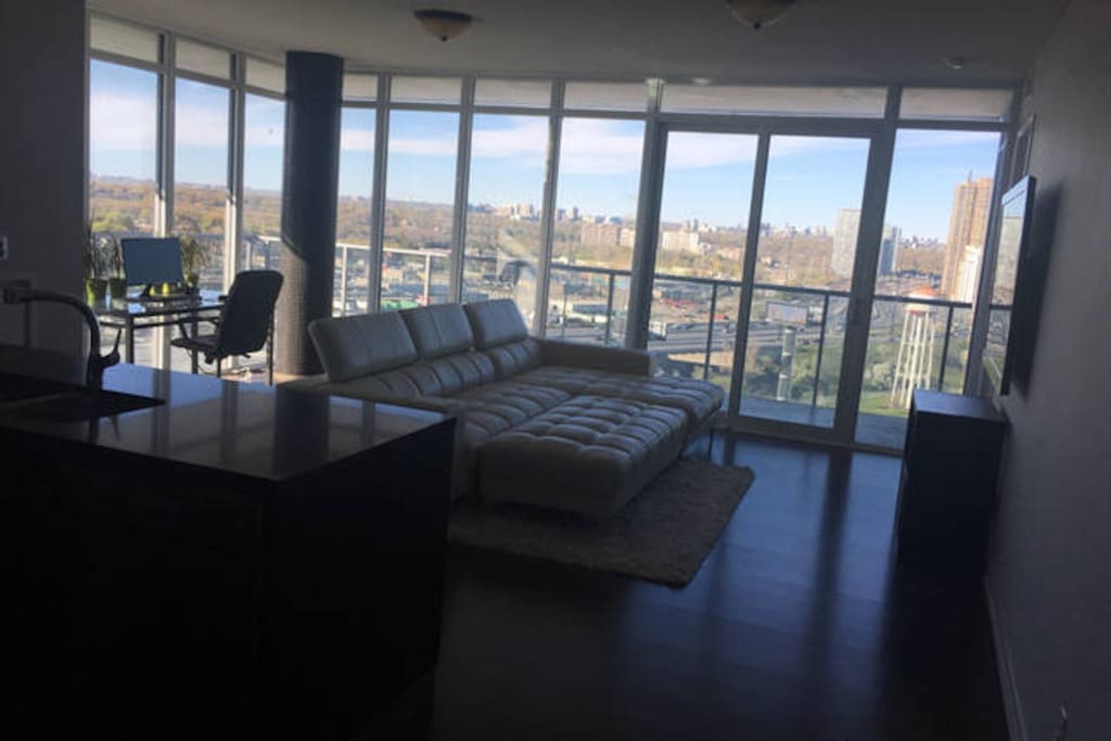 Large living room with 65 inch TV, cable, and Wifi.