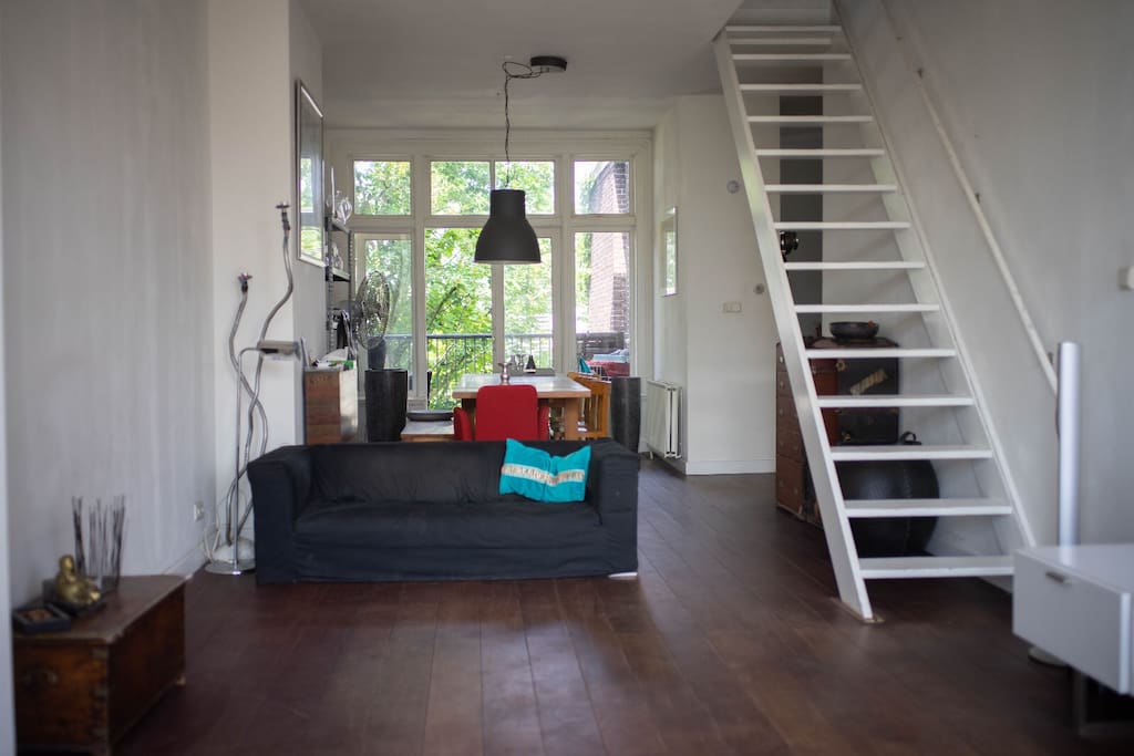Living room with large balcony at the back. Stairs to master bedroom and terrace