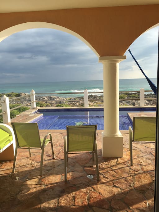 view from the kitchen. Large patio and pool. *upstairs unit also has access to the pool
