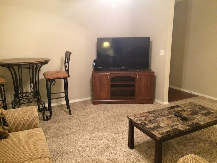 Very comfortable Family Room with sofa, love seat, coffee table, end tables, pub table w/pub chairs, lamps, and 50” television