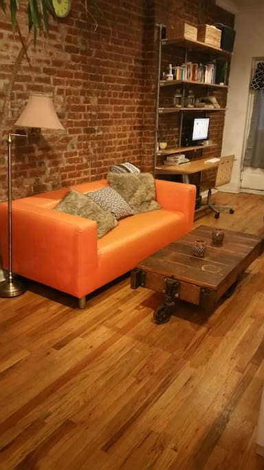 Our couch with large table and beside is the office area.