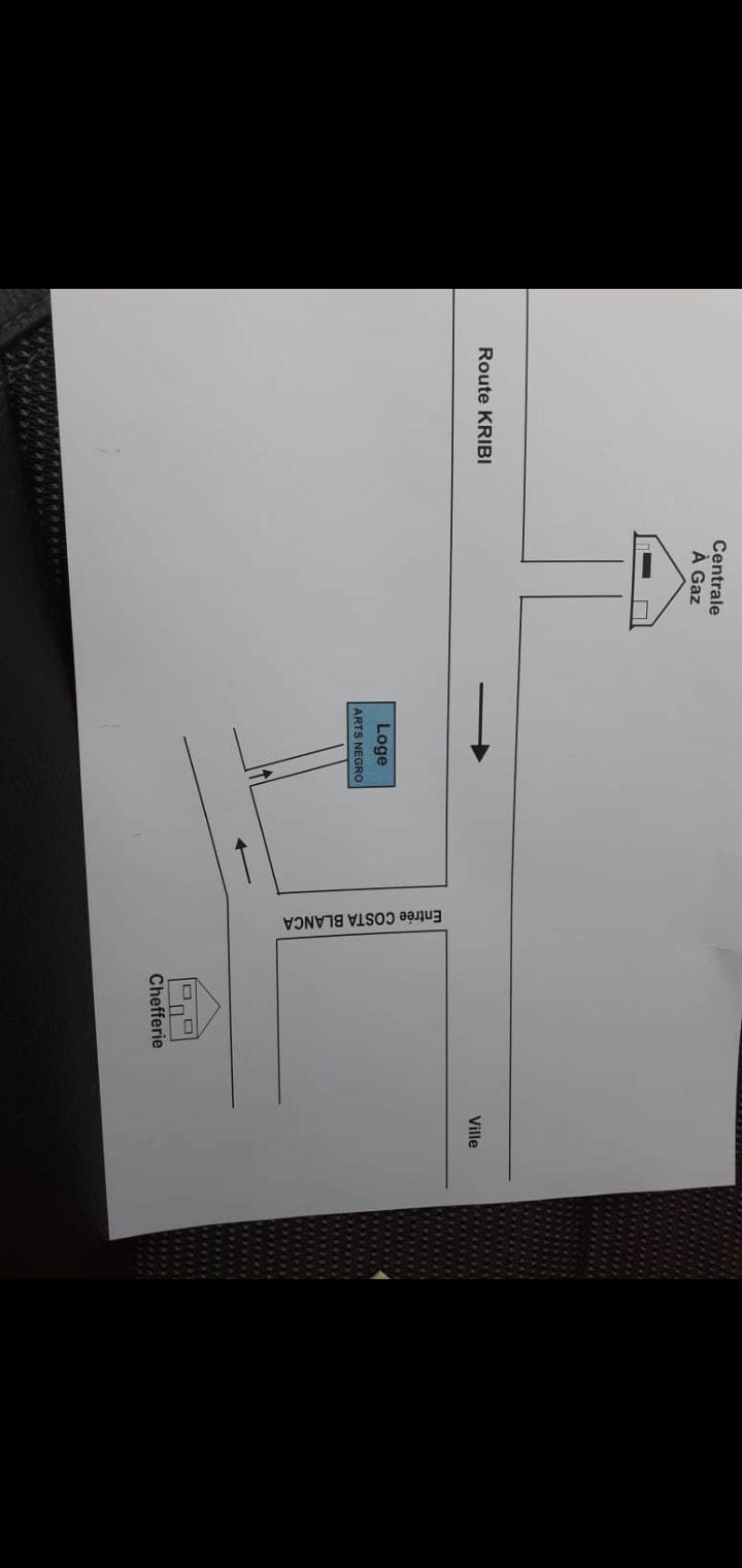 A simple map is displayed, indicating directions with labeled streets and a destination. Clear arrows point towards an entryway, enhancing navigational clarity. The layout allows for easy understanding of the surrounding area, with straightforward labeling for nearby landmarks.