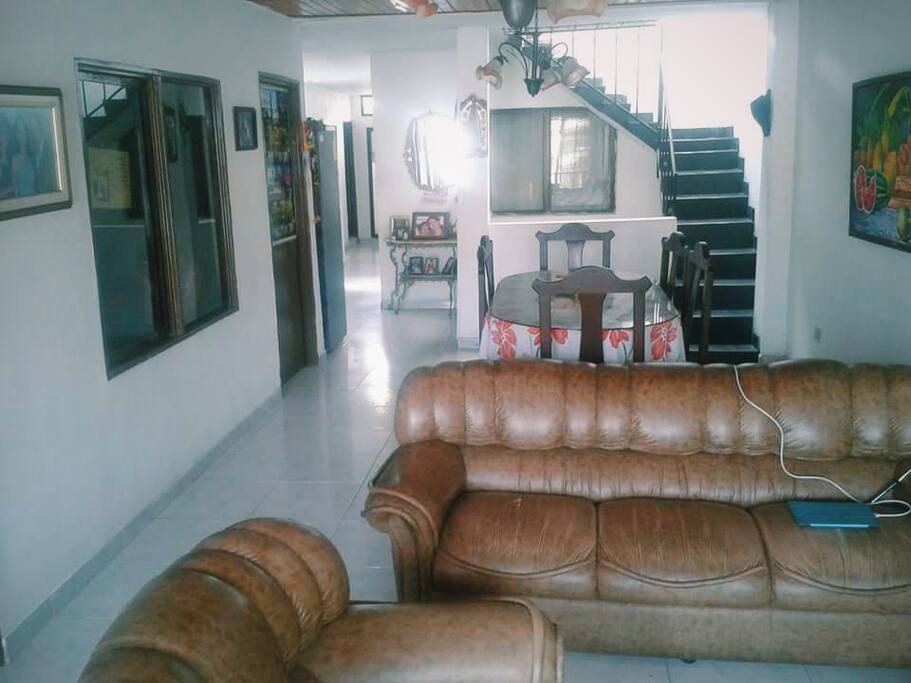 The living room is the first thing you see when you come in. At your right you'll see the stairs to go up to where you will be staying. To your left you'lls the some rooms, and at the end it's the kitchen and another bathroom that you can use if you want.