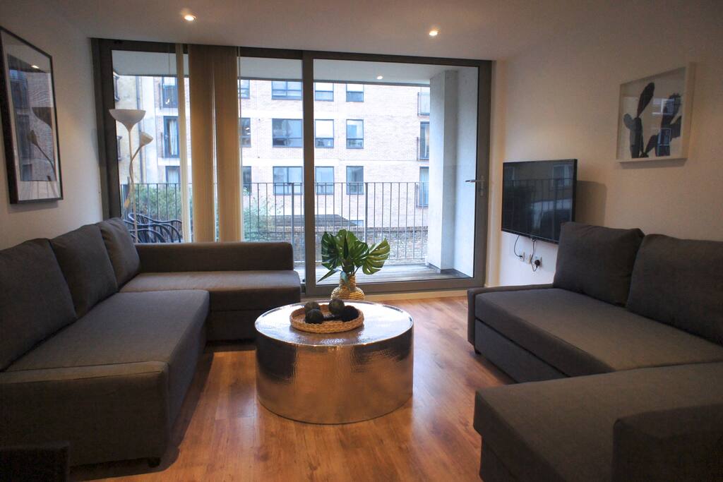 Here's your living room with private balcony and two double sofa-beds