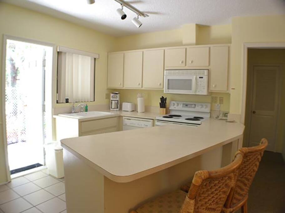 Kitchen with dw, oven, microwave and kitchenware.