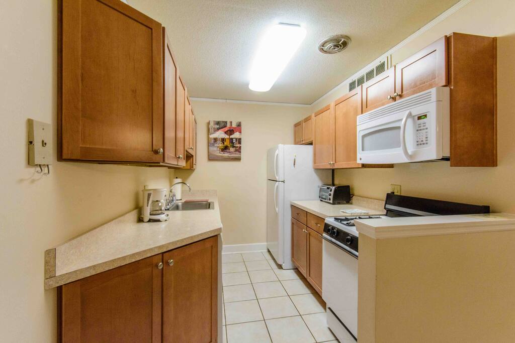 Kitchen with gas stove, microwave over the stove, dishwasher and fully furnished.