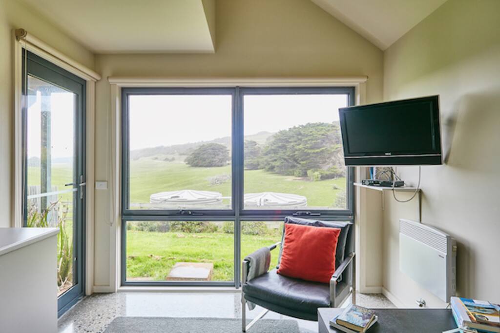 Living room and kitchen looking onto surrounding farmland