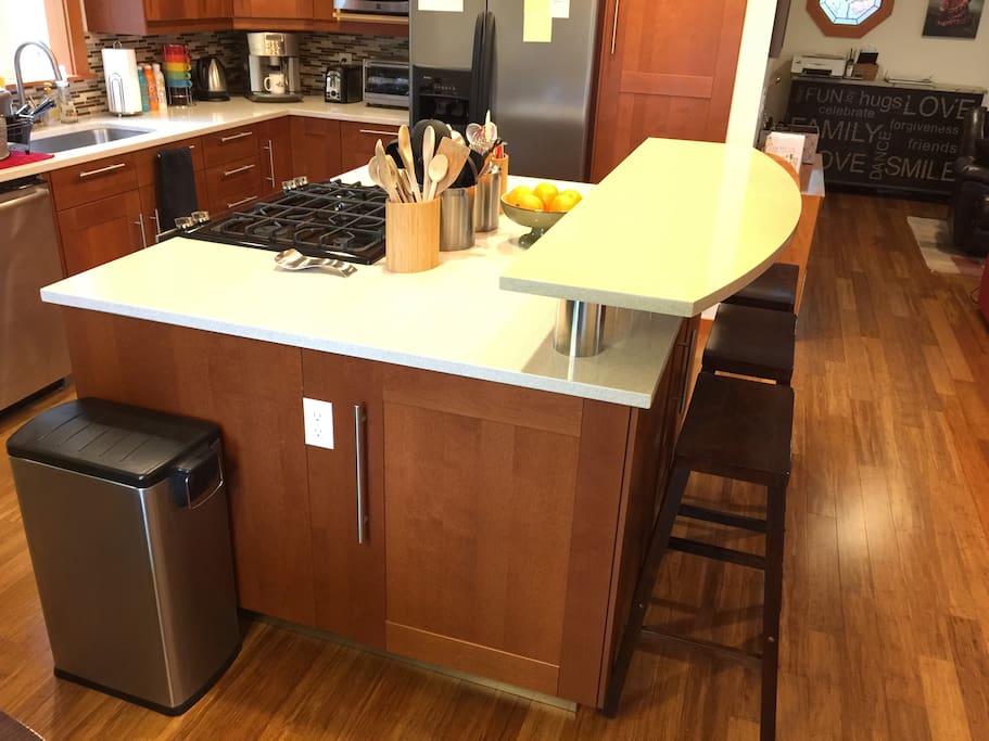 The kitchen's center island has a bar that seats three.