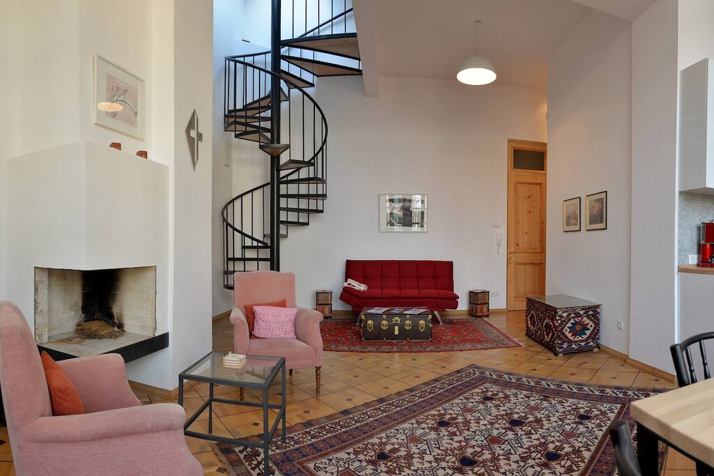 living room with modern stairway - the couch in the back transforms into a spacious double bed just next to the second bathroom