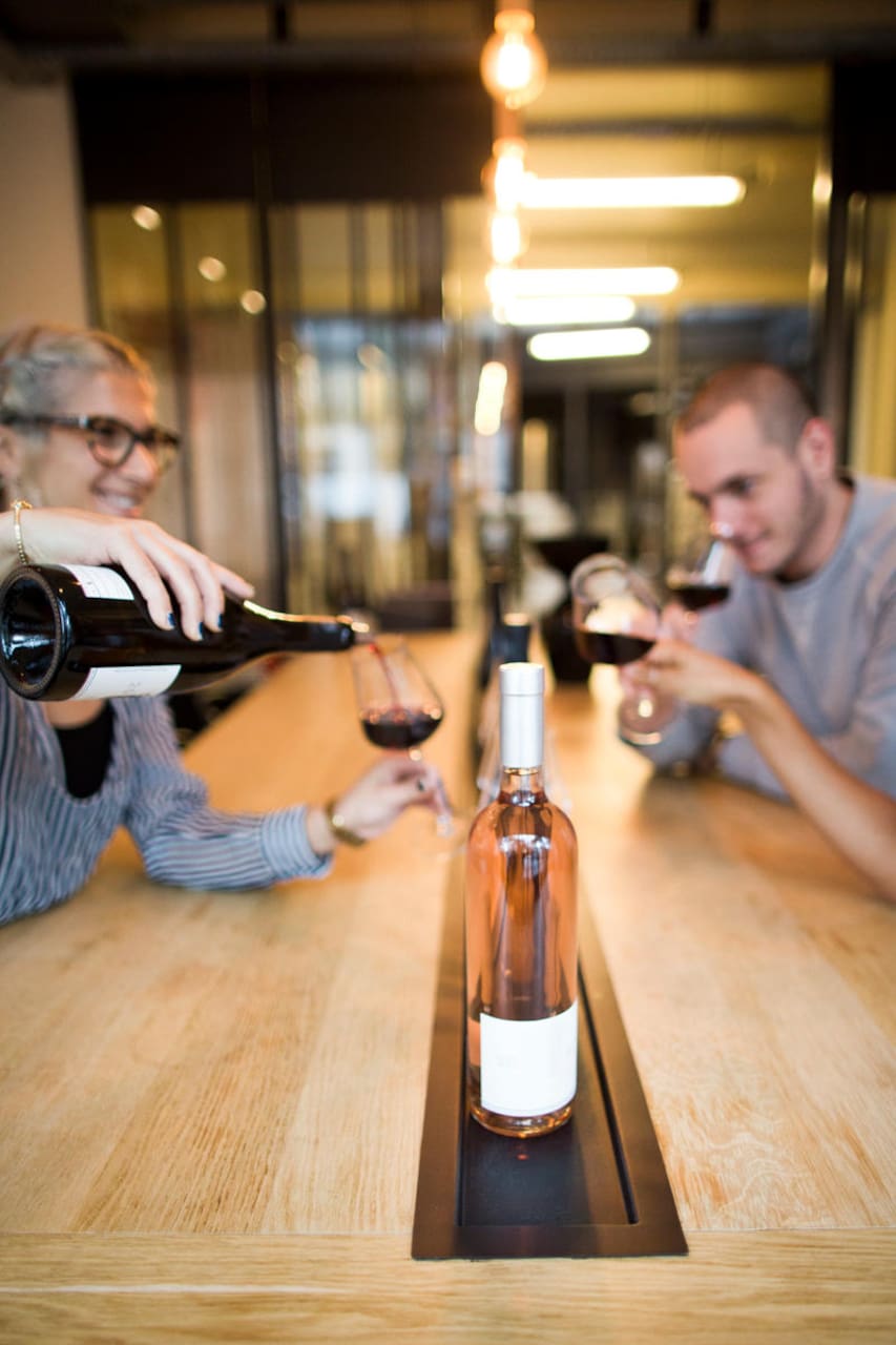 woman pouring a glass of wine at the paris urban winery