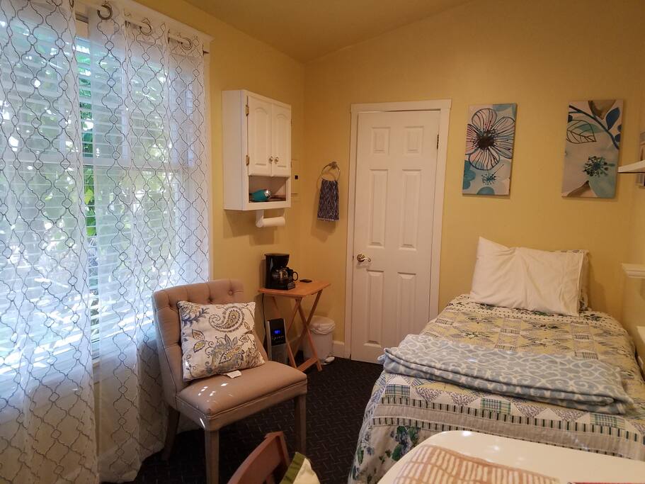 Brightly lit, studio room for one person.