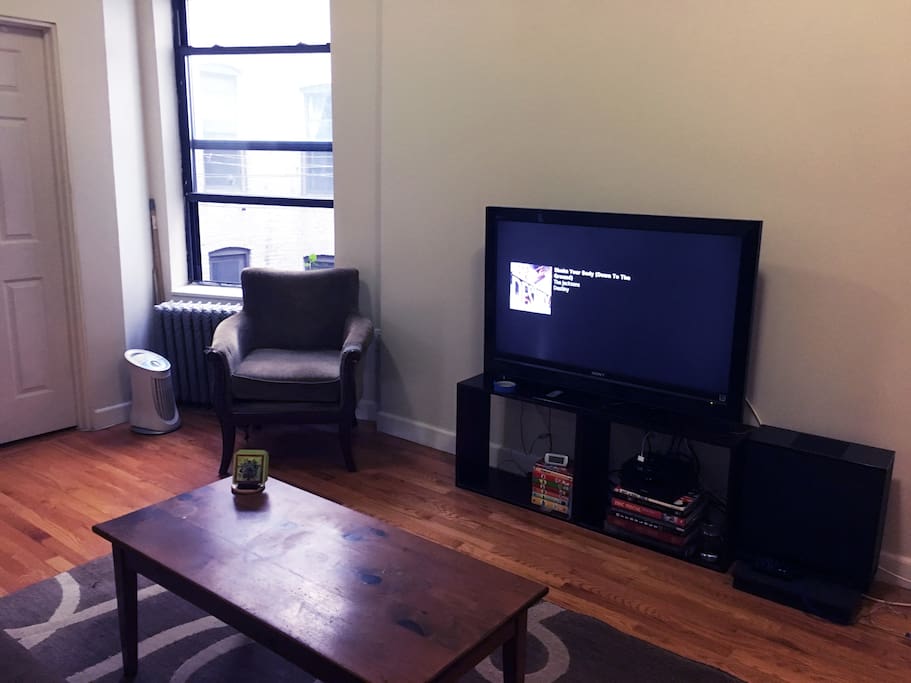 Living area w/ view of large window and tv