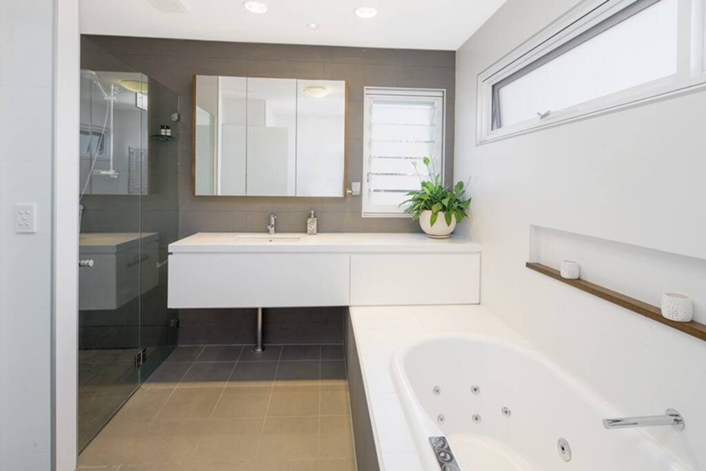 main bathroom with spa bath and rain shower