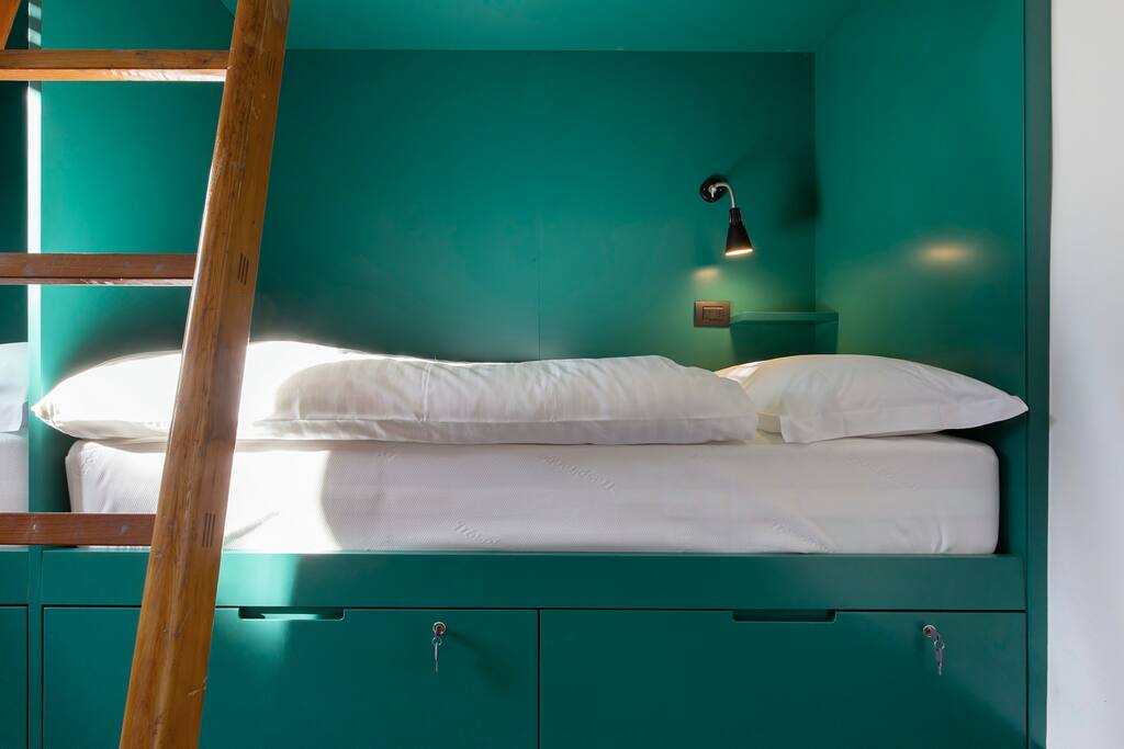 comfortable bed, with high mattress and quilt
