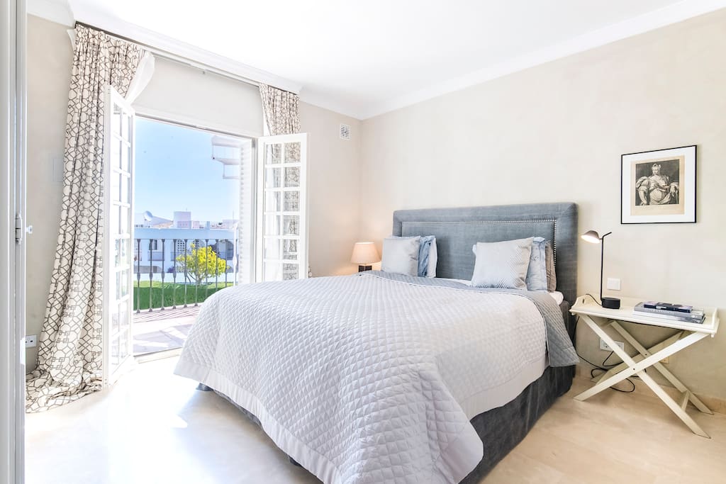 Nice master bedroom with plush beddings, ensuite bathroom and private terrace with sea and golf views