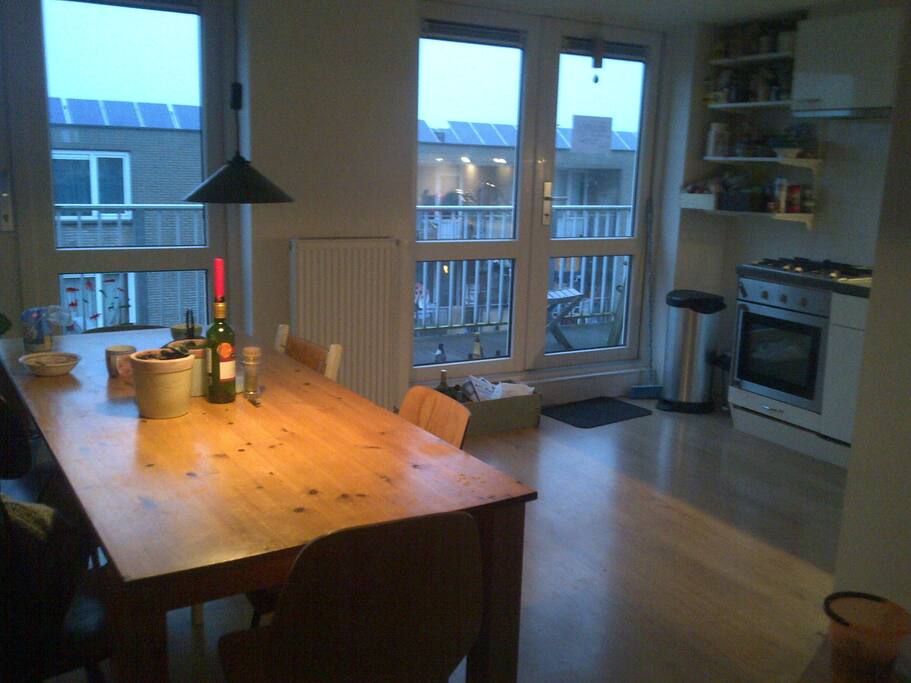 Dinner Table, open kitchen + access to the balcony