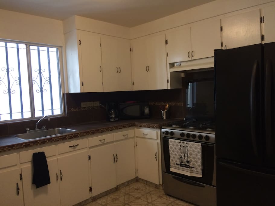 Kitchen with pots, pans, spices, teas, cooking utensils, utensils, etc.