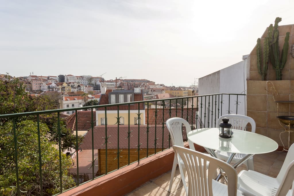 Backyard balcony with view over the city rooftops and Tagus River.