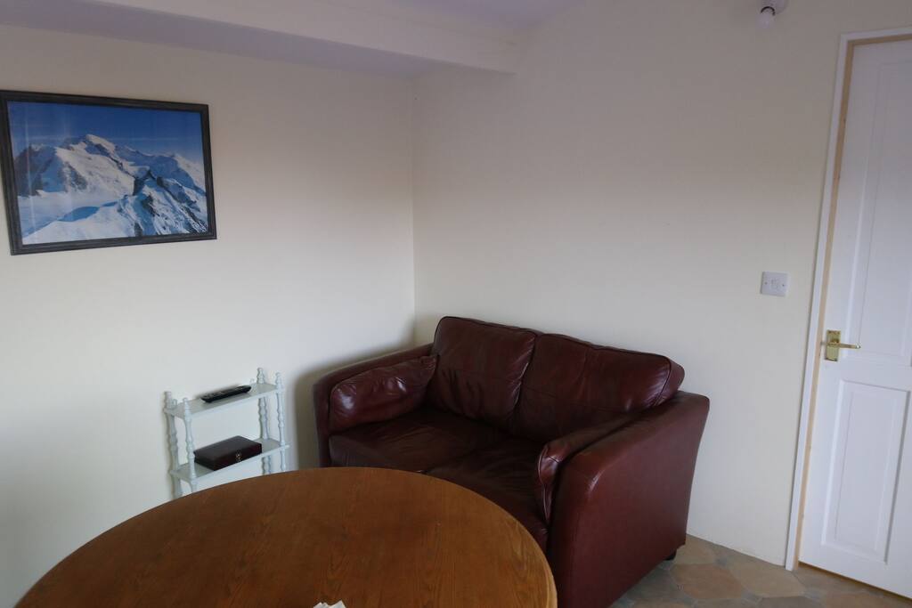 main room with TV and table for meals