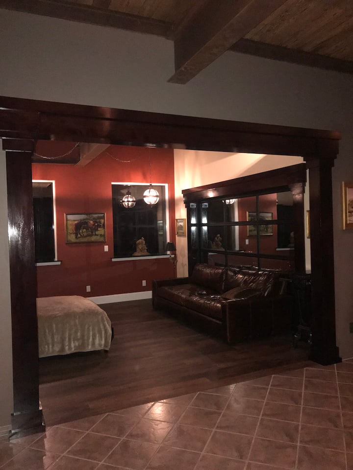 Newly added Study.  Once the second part of the tandem garage now an elegant sitting room with a beautiful maple Murphy bed with matching heavy columns throughout.   