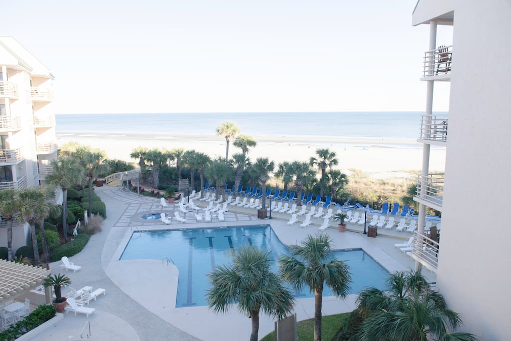 From your balcony you can see the ocean across the pool.