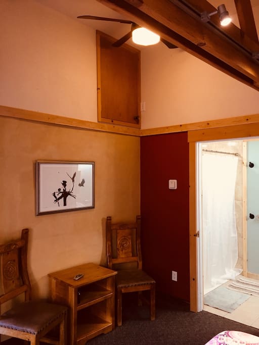 Sitting nook in room with vaulted ceiling and fan