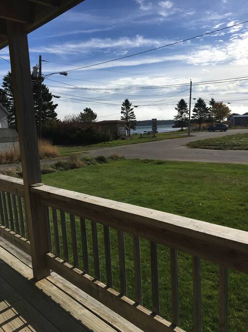 Decks overlooking quiet road and the salt waters of the Lubec Channel.