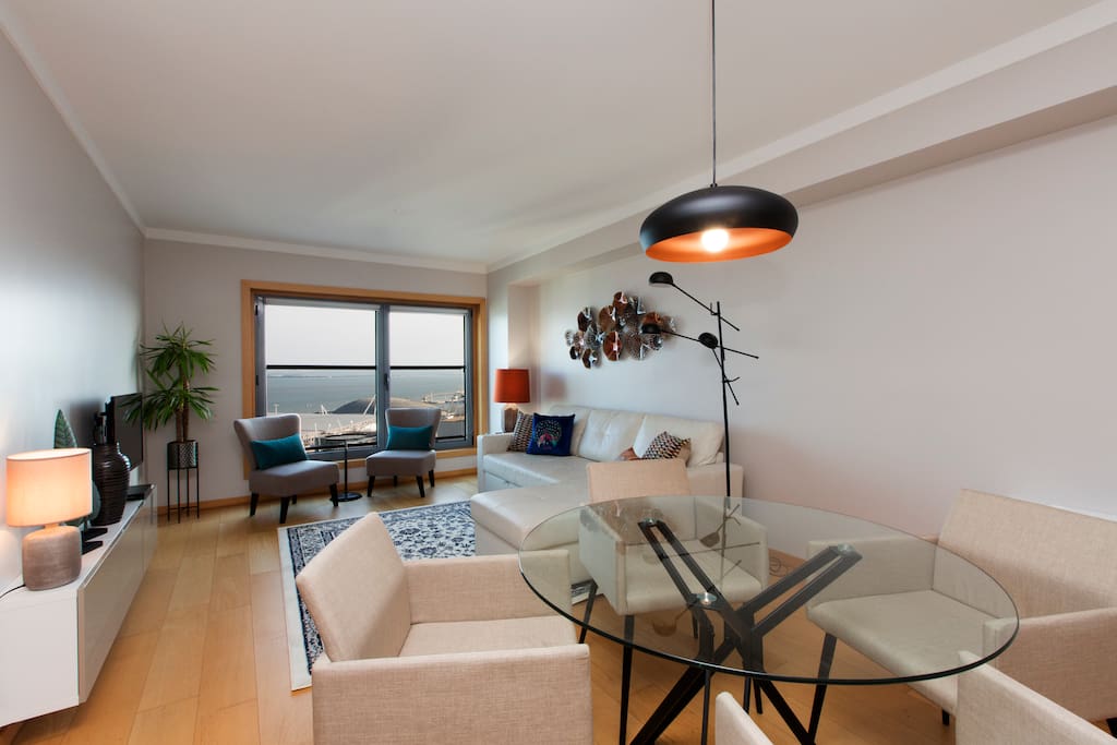 Living room with air conditioner and cable TV with 180 channels.
