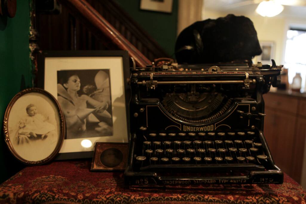 Every square foot is outfitted with paintings, a piano, vintage hats and dresses, antique collectibles, and any number of wooden chests.
