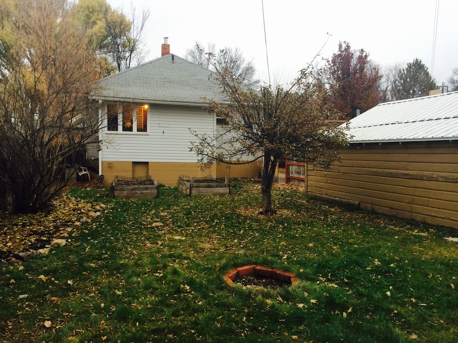 Fenced in backyard with fire pit